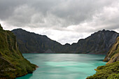 View at the crater lake of the active volcano Pinatubo under grey clouds, Angeles, Luzon, Philippines, Asia