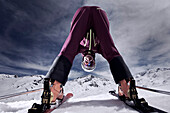 Female skier looking through legs, Kappl, Tyrol, Austria