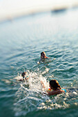 Children splashing in lake Worthsee, Bavaria Germany