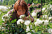 Women Smelling A Rose, Rose Garden At The Chateau De Miserey, Eure (27), Normandy, France