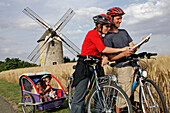 Tourist Looking At Their Map In Front Of The Windmill Of Ozoir-Le-Breuil, Eure-Et-Loir (28), France