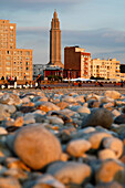 Shingle Beach At Sunset In Front Of The Buildings And Saint-Joseph Church Built By The Architect Auguste Perret, Classed As World Heritage By Unesco, Le Havre, Seine-Maritime (76), Normandy, France