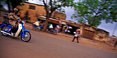 A Woman Getting About On A Moped, The Most Common Means Of Transport In Bobo-Dioulasso, Burkina Faso