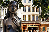 Statue Of A Bare-Breasted Woman In Front Of The Cafe De Bourg De Four, Place Du Bourg-De-Four, Geneva, Switzerland