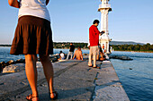 Bathing And Relaxing In Front Of The White Lighthouse Of The Bains Des Paquis In The Geneva Harbour On Lake Geneva, Geneva, Switzerland