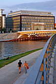 Couple Walking On The Banks Of The Spree, Berlin, Germany