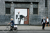 Bicycles And Passers-By In Front Of The Facade Of The Building Designed By K. De Bazel, Amsterdam, Netherlands