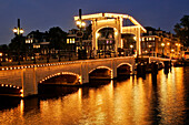 The Skinny Bridge, 'Magere Brug', The Most Famous Of The 1280 Bridges In Amsterdam. A Traditional Wood, Double-Swipe Bridge Linking The Two Sides Of The Amstel, Amsterdam, Netherlands