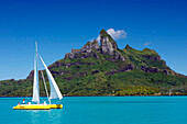 Sailboat Passing In Front Of Otemanu Mountain, Island Of Bora Bora, Leeward Islands, French Polynesia