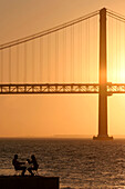 Sunset Over The 25Th Of April Bridge, Cacilhas Across From Lisbon On The Other Bank Of The Tagus, Portugal