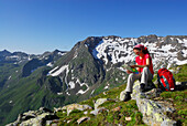 Female hiker reading map, Stubai Alps, Trentino-Alto Adige/South Tyrol, Italy