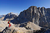 Woman looking at south face of Vernel and Marmolada, Dolomites, Trentino-Alto Adige/South Tyrol, Italy