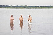 Three naked men inside Cospuden Lake, Leipzig, Saxony, Germany