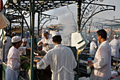 Chefs at a food stall on Djemaa el Fna Square, Marrakesh, Morocco, Africa