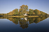 Reflection of trees in autumn on water ditch, Great Garden, Herrenhausen Gardens, Hanover, Lower Saxony, Germany