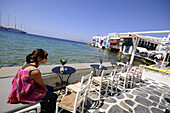 People at cafes at Venetia quarter, Mykonos island, Cyclades, Greece, Europe