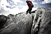 Young woman balancing over limestone, Weissplatte, Montafon, Vorarlberg, Austria