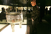 Tourist looking at exhibited object at the Shanghai Museum, Shanghai, China, Asia