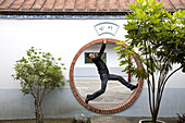German tourist inside the moon gate of a temple, Tainan, Republic of China, Taiwan, Asia