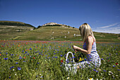 Italy Umbria Norcia Castelluccio di Norcia Italy Umbria Norcia Castelluccio di Norcia Woman in poppies field MODEL RELEASE 1108