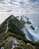 Mackerel´ sky at sunrise over Nugget Point lighthouse and The Nuggets Catlins Coast New Zealand