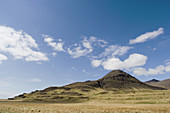 volcanic mountain range with blue sky