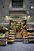 Traditional grocery store selling fruit and vegetable seen from front in a side street of the heart of Florence (Firence),  Tuscany,  Italy,  Southern Europe