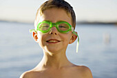 Happy boy about to swim wearing goggles