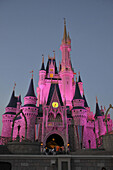 Evening illuminated view of Cinderella Castle at Walt Disney Magic Kingdom Theme Park Orlando Florida Central