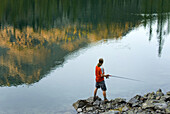 Fisherman trying his luck at Copper Glance Lake,  Okanogan National Forest Wasington USA