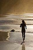 Woman running on the beach  Maui,  Hawaii  Model released