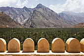 Detail of the fort walls in Fort Nakhl,  Nakhal,  Oman with a view of the Hajar Mountains in the background