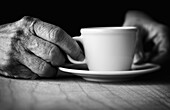 Time for coffee  Hands of elderly woman holding a cup