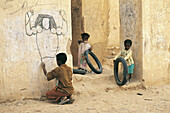BOY DRAWING ON A WALL,  TARIM,  HADRAMAWT,  YEMEN