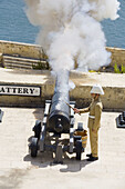 Firing of the noon day gun,  at the Saluting Battery,  Upper Barracca Gardens,  Valletta,  Malta