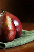 Red Anjou pears on green cloth