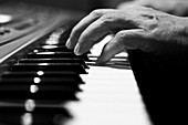 Man´s hand playing the piano