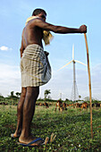 A shepherd herding his goats past the wind turbines Kanyakumari,  India