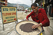 Woman sorting seeds in Pokhara,  Nepal