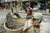 Construction workers hauling gravel in a traditional basket  Pokhara,  Nepal