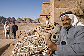 Jordan,  Petra Bedouin sells crafts at tombs,  besides tourists