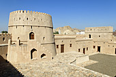 historic adobe fortification Mahadah fort or castle near Buraimi,  Hajar al Gharbi Mountains,  Al Dhahirah Region,  Sultanate of Oman,  Arabia,  Middle East