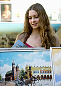 Poland Krakow,  young woman by a paintings