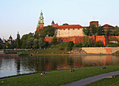 Poland,  Krakow,  people resting by Vistula river,  Wawel Hill