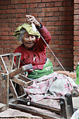 Nepal,  Kathmandu Valley,  Bhaktapur,  woman working on a handloom