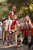 India,  Rajasthan,  Udaipur,  wedding procession,  bridegroom on horseback