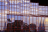 Cologne Cathedral and Hohenzollern Bridge reflecting in the facade of a hotel, Cologne, Rhine river, North Rhine-Westphalia, Germany