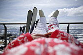 Junge Frau entspannt sich auf der Terasse, Skifahren, Flims, Crap Sogn Gion, Graubünden, Schweiz