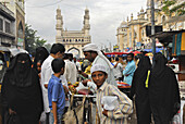 Muslim women wearing a chador at a streetmarket in front of Charminar, Hyderabad, Andhra Pradesh, India, Asia