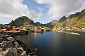 Rorbu huts on the waterfront under clouded sky, Lofoten, Norway, Scandinavia, Europe